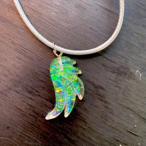 Resin handmade angel wing pendant on 17” corded necklace.